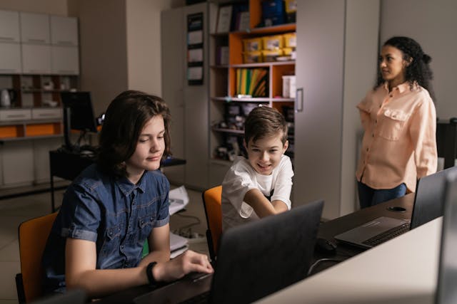 "kids using laptops"